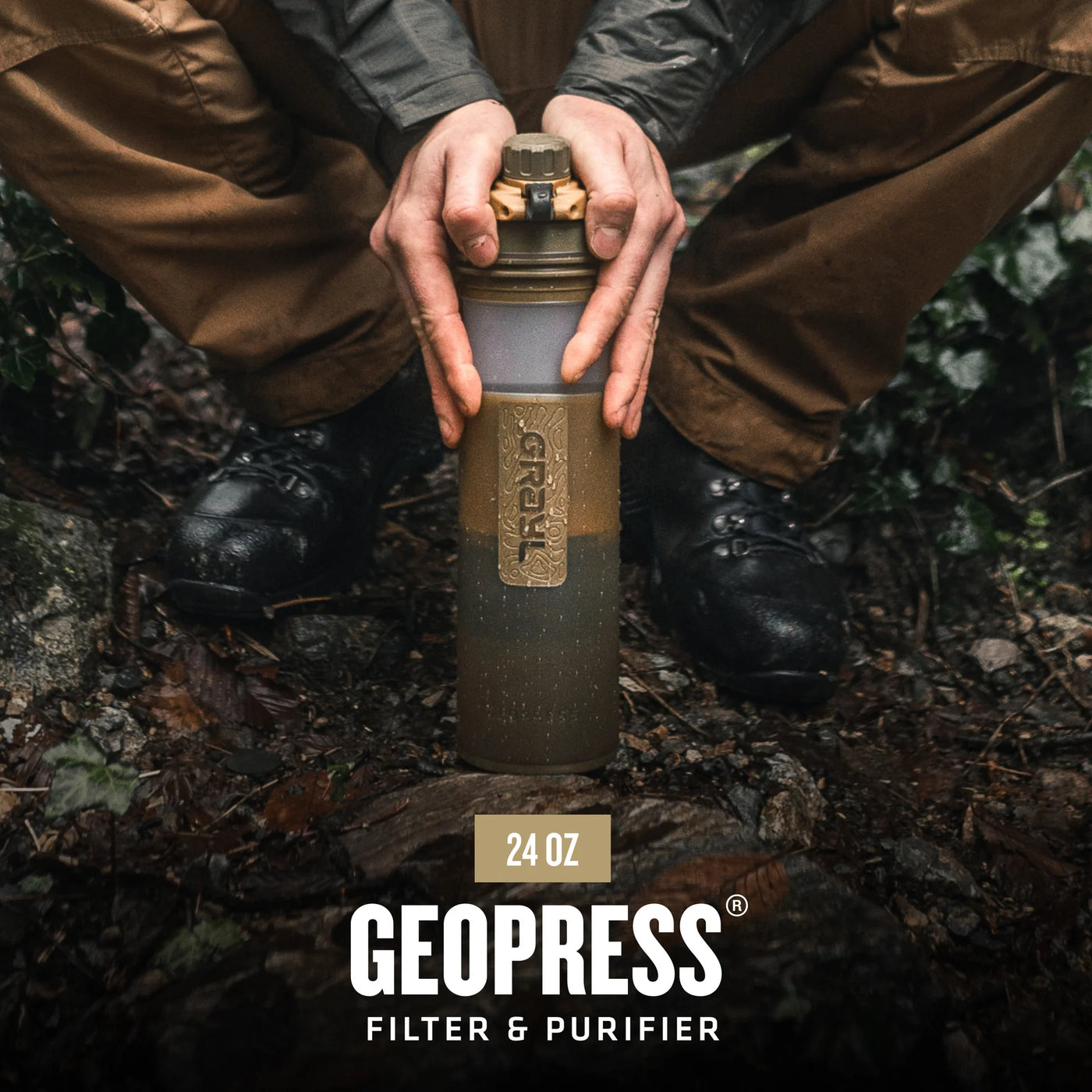 Grayl GEOPRESS water purifier bottle for outdoor survival and emergency preparedness, shown in a rugged outdoor setting.