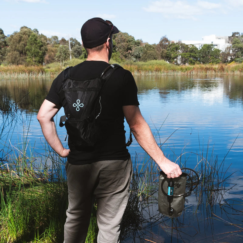 Portable water purification bag for outdoor survival and emergency preparedness, featuring a durable black design.