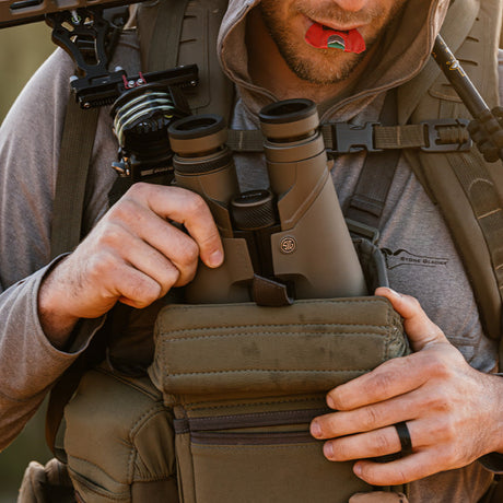 Tactical binocular harness for outdoor survival and emergency preparedness, featuring durable straps and secure fit.