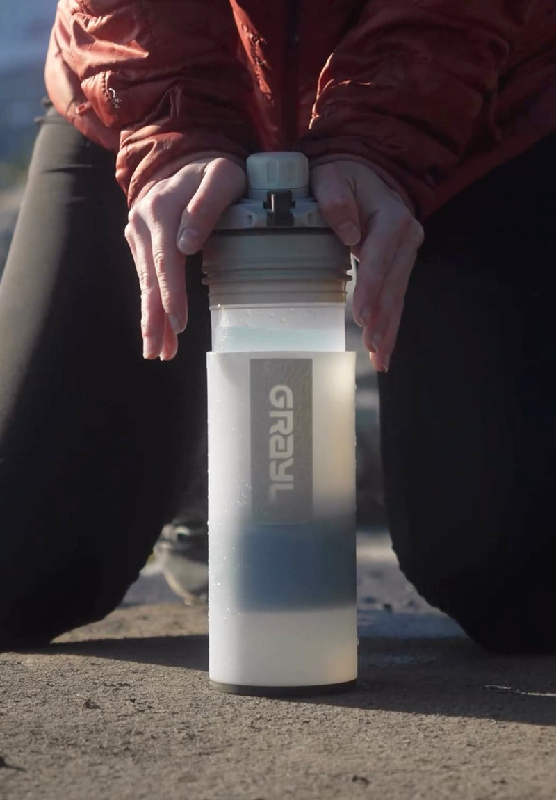 Grayl water purifier in action, showcasing portable water purification for outdoor survival and emergency preparedness.