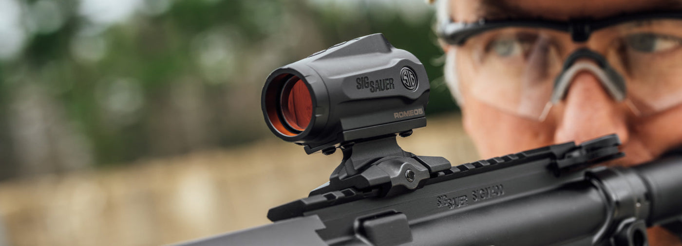 Sig Sauer ROMEO5 Gen II red dot sight on tactical rifle, ideal for outdoor survival and emergency preparedness.