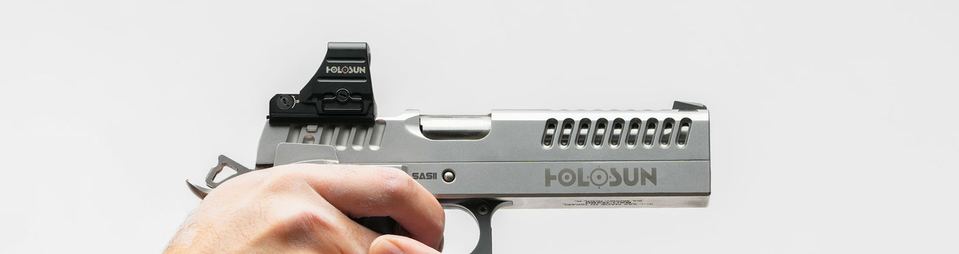 Holosun pistol reflex sight, compact tactical optic for precision shooting and outdoor survival gear.