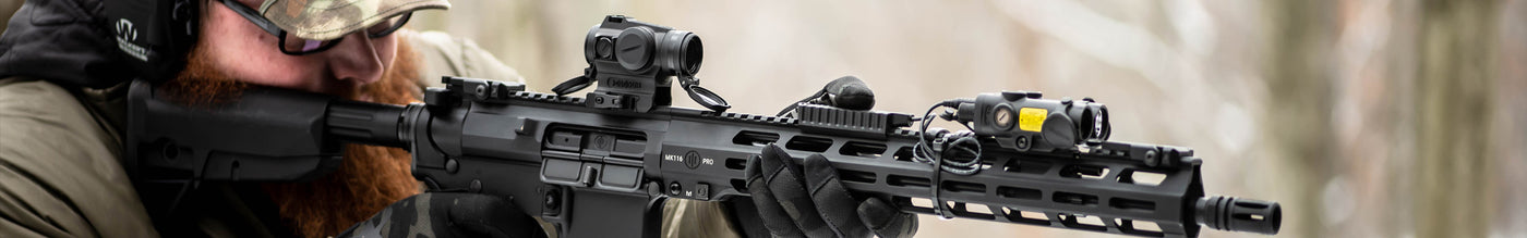 Holosun rifle red dot sight mounted on tactical firearm for precision aiming in outdoor survival scenarios