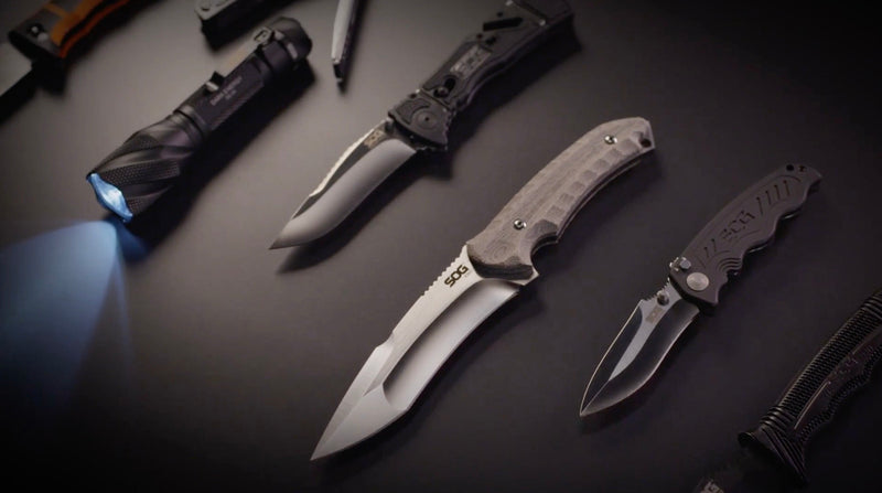 Tactical SOG knife with black handle and blade, ideal for outdoor survival and emergency preparedness.