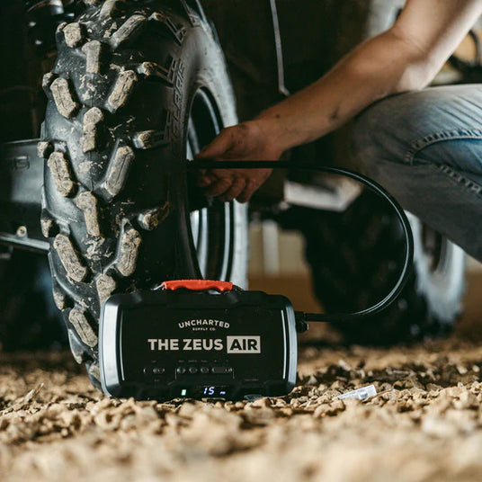 Tactical Zeus Air rifle in rugged outdoor setting for survival and emergency preparedness.
