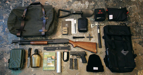 Well-stocked bug out bag with survival gear including water filter, food, shelter, and first aid kit laid out on the ground, ready for emergency evacuation.