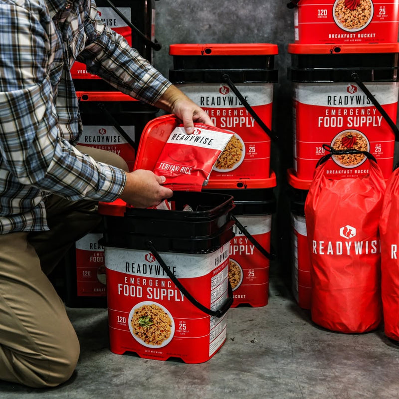 Assorted emergency food supplies for survival and preparedness, featuring canned goods and freeze-dried meals.